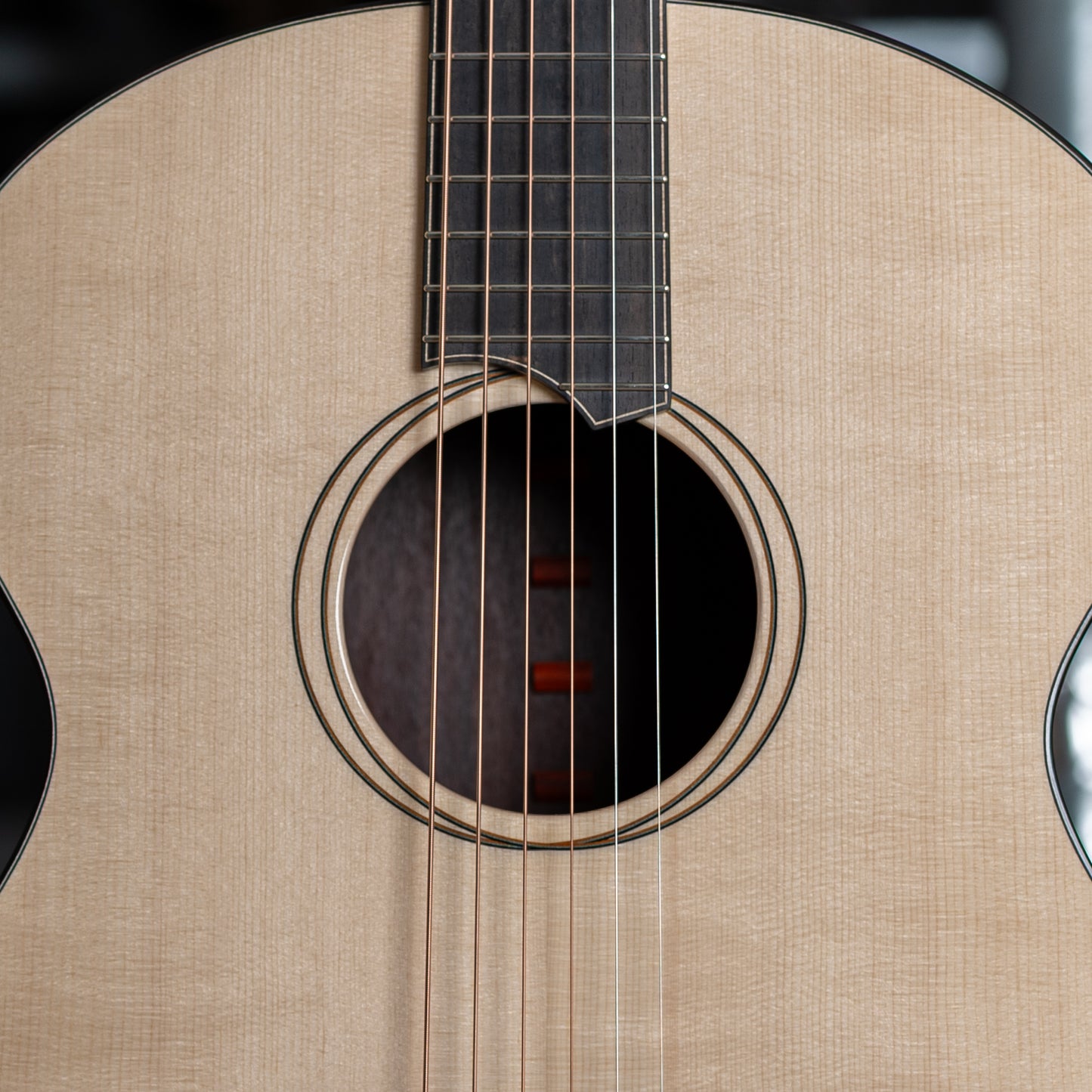 Close-up of an acoustic guitar's soundhole and strings