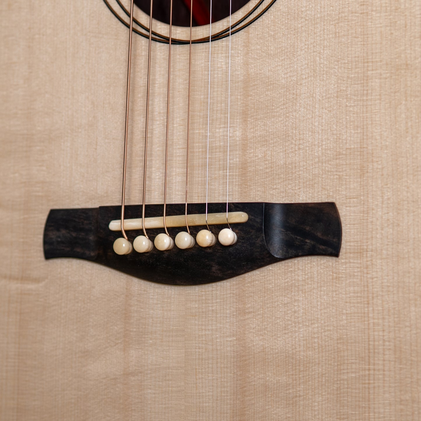 Close-up of a guitar's bridge with strings and bridge