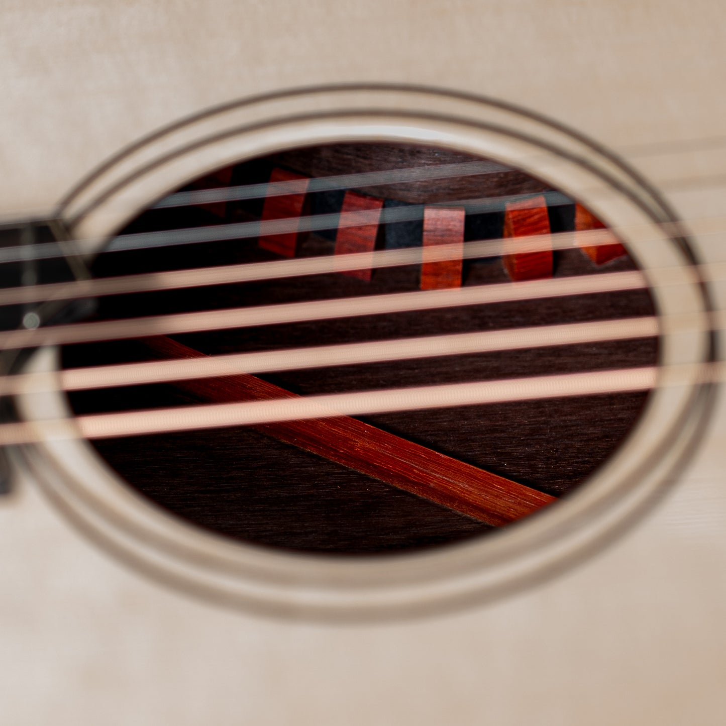Close-up of an acoustic guitar's interior through the soundhole.