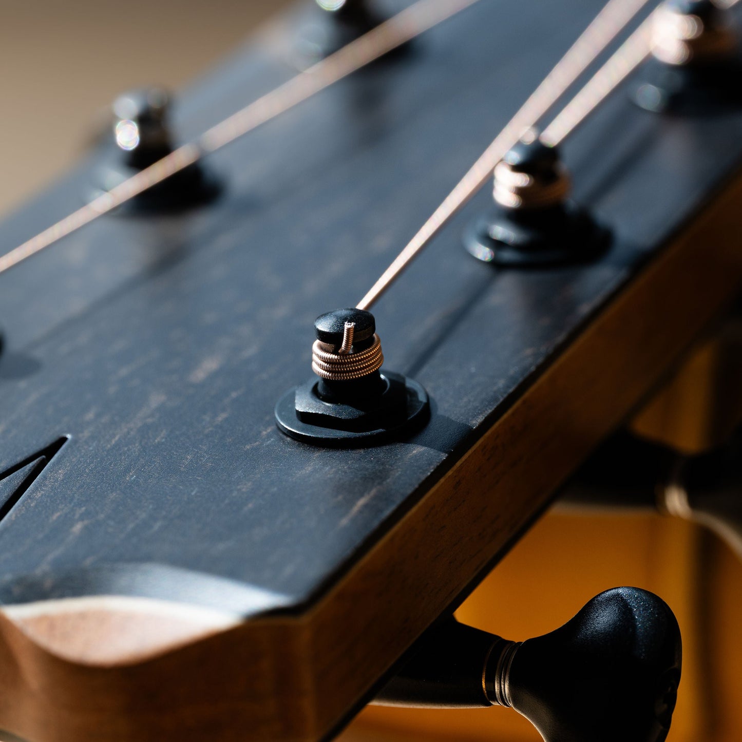 Close-up of a guitar headstock with tuning pegs