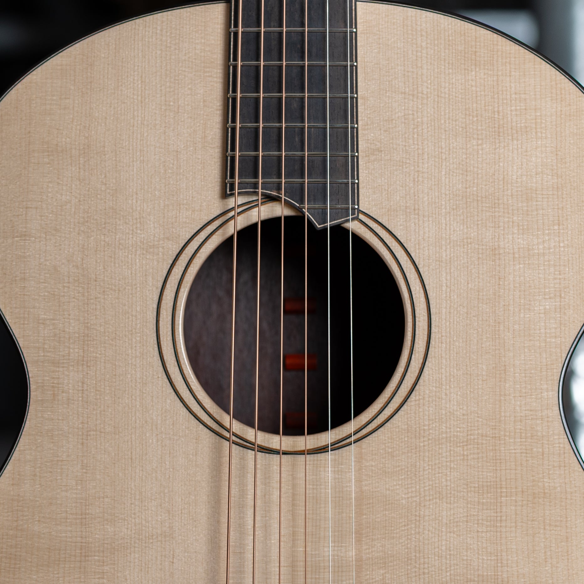 Close-up of an acoustic guitar's soundhole and strings