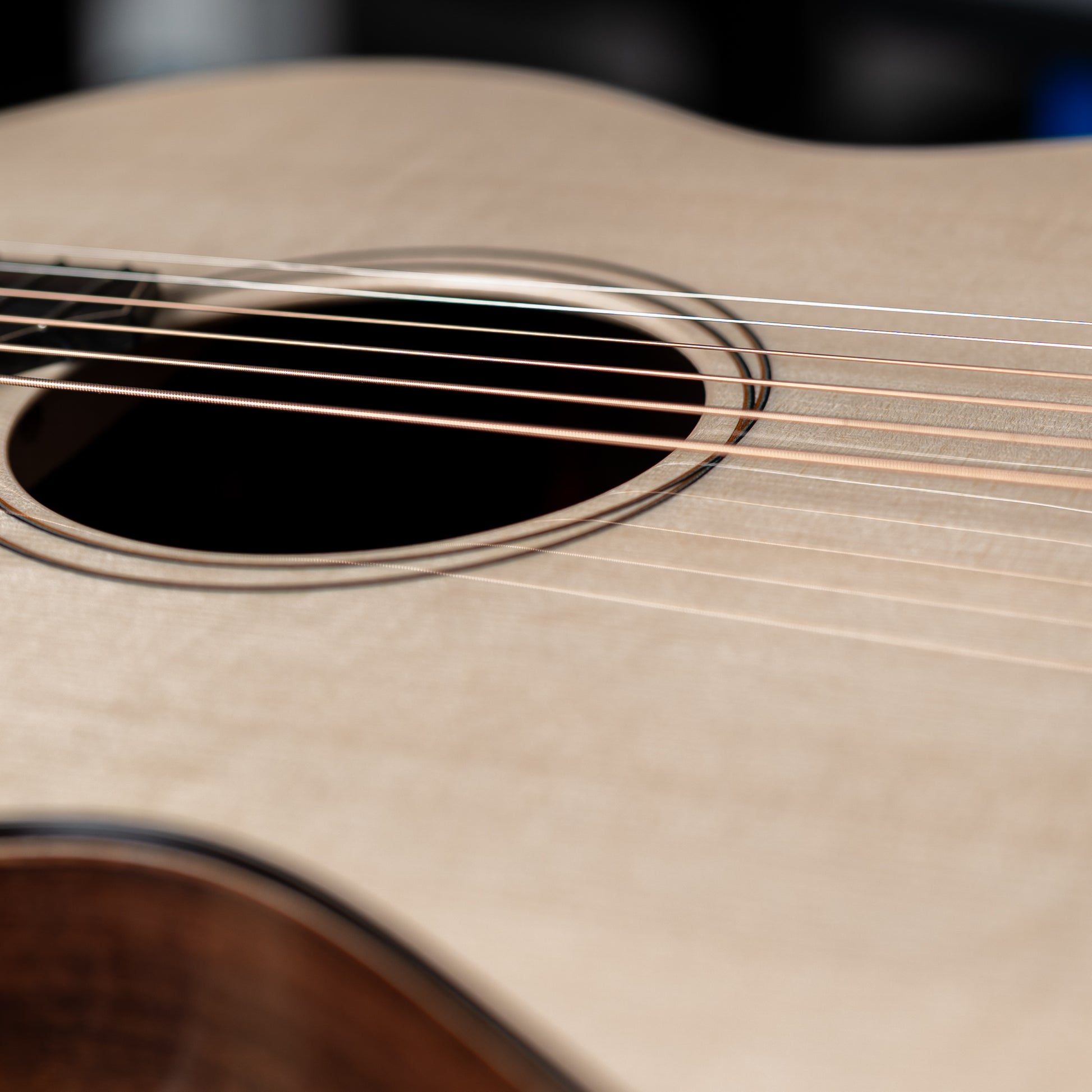 Close-up of an acoustic guitar's soundhole and strings
