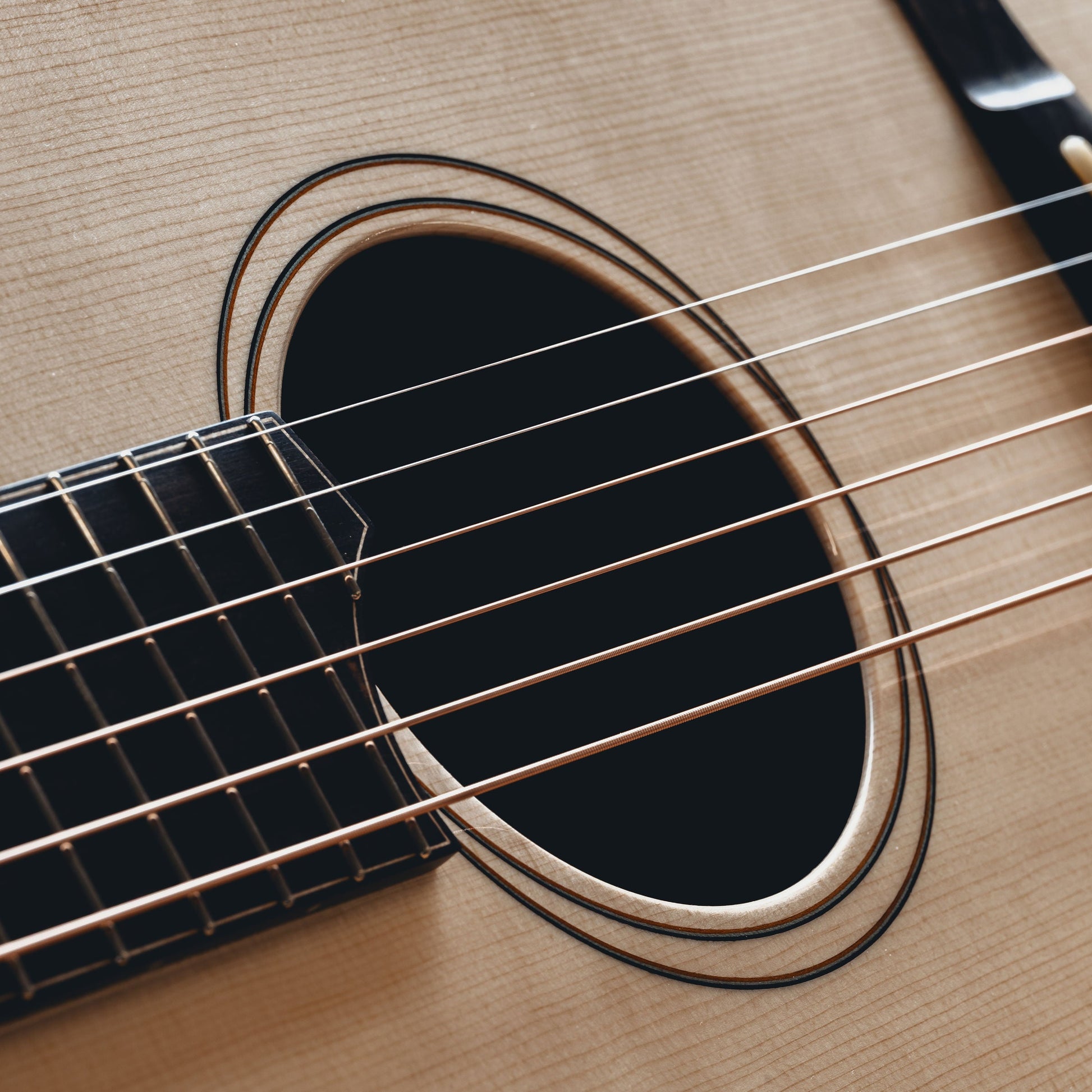 Close-up of an acoustic guitar's soundhole and strings